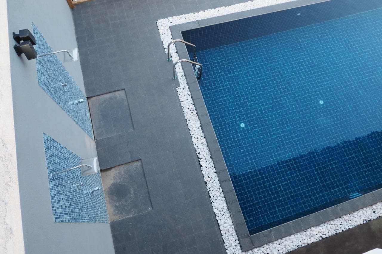 Sunloungers lined up along the poolside