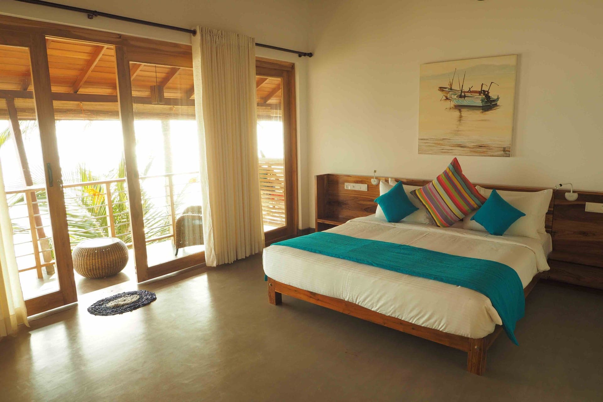 Ocean-view room interior with kingsize bed and high ceiling